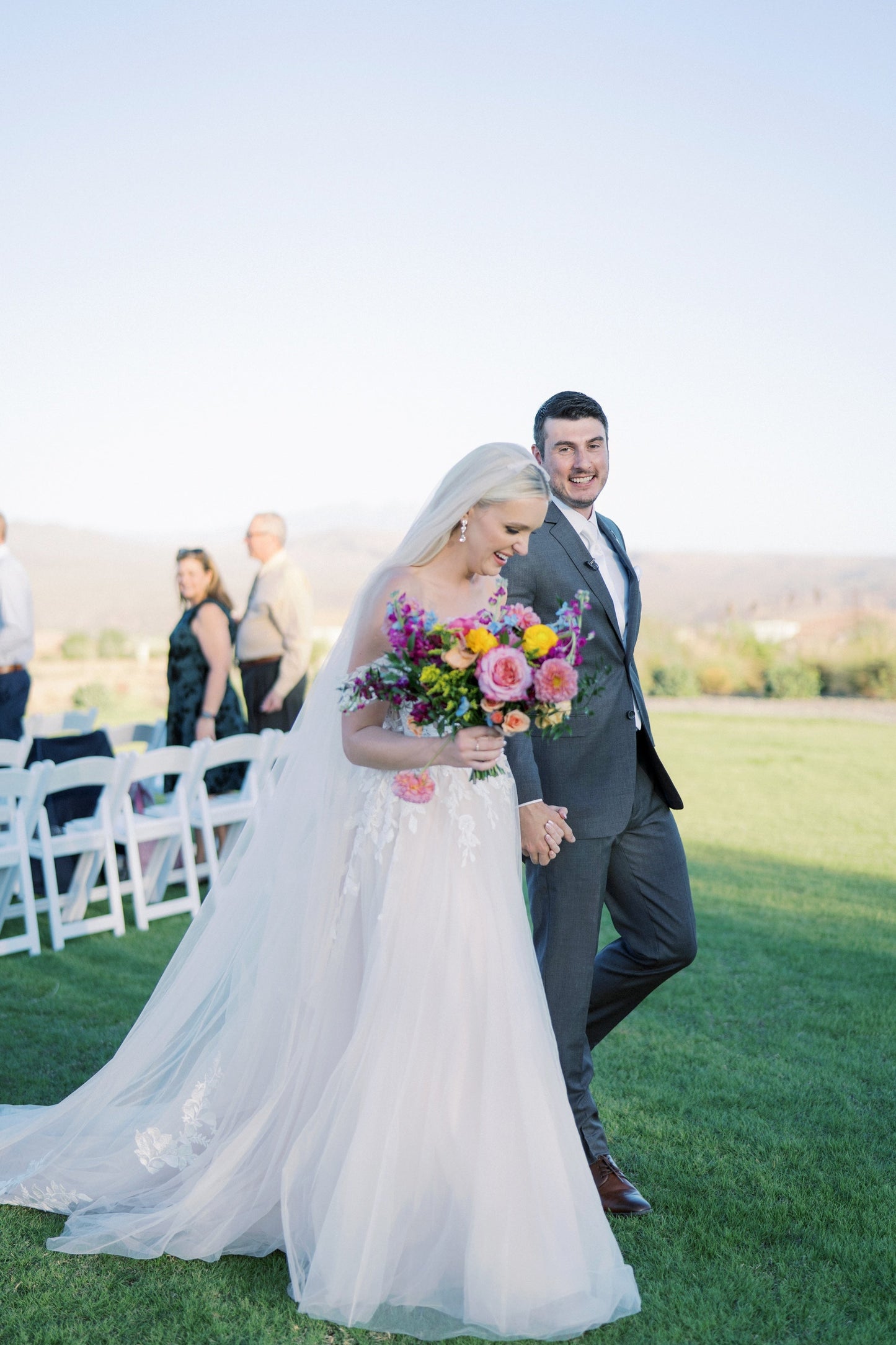 bride and groom with floral bouquet