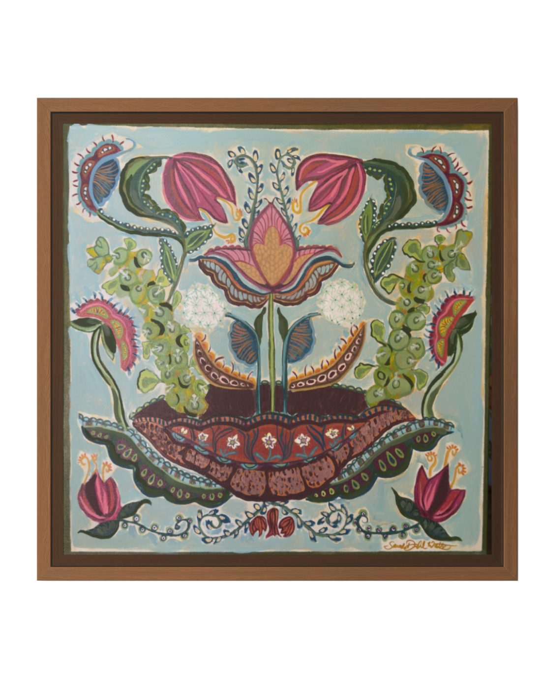 A framed folk art print featuring a stylized floral design with pink flowers, green leaves, and a central lotus motif on a light blue background, enclosed in a brown wooden frame.